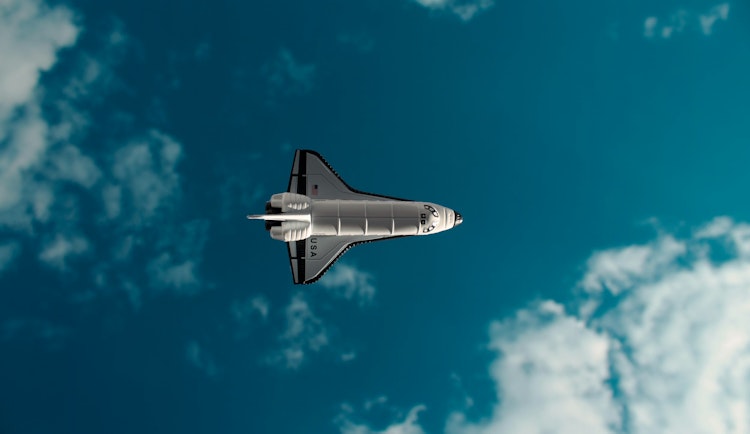 white and black jet plane in mid air under blue sky during daytime