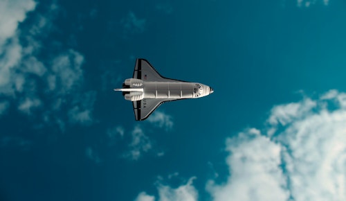 white and black jet plane in mid air under blue sky during daytime