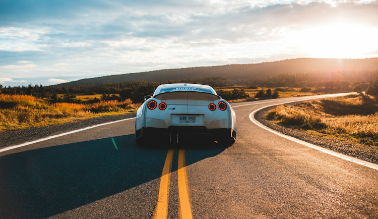 silver sports coupe on asphalt road