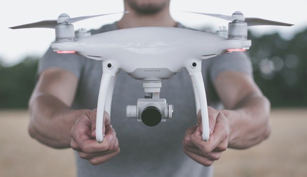 person holding quadcopter drone