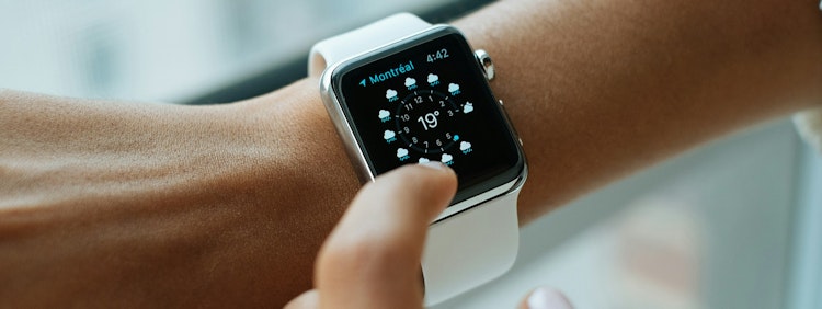person wearing silver aluminium case Apple Watch with white Sports Band
