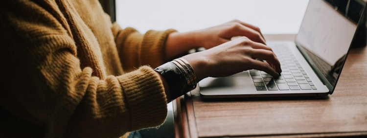 person sitting front of laptop