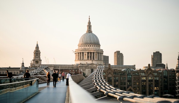 people walking on bridge near building