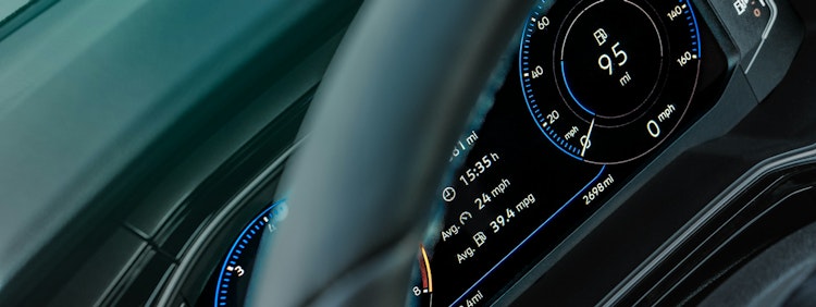 gray car steering wheel and instrument panel cluster