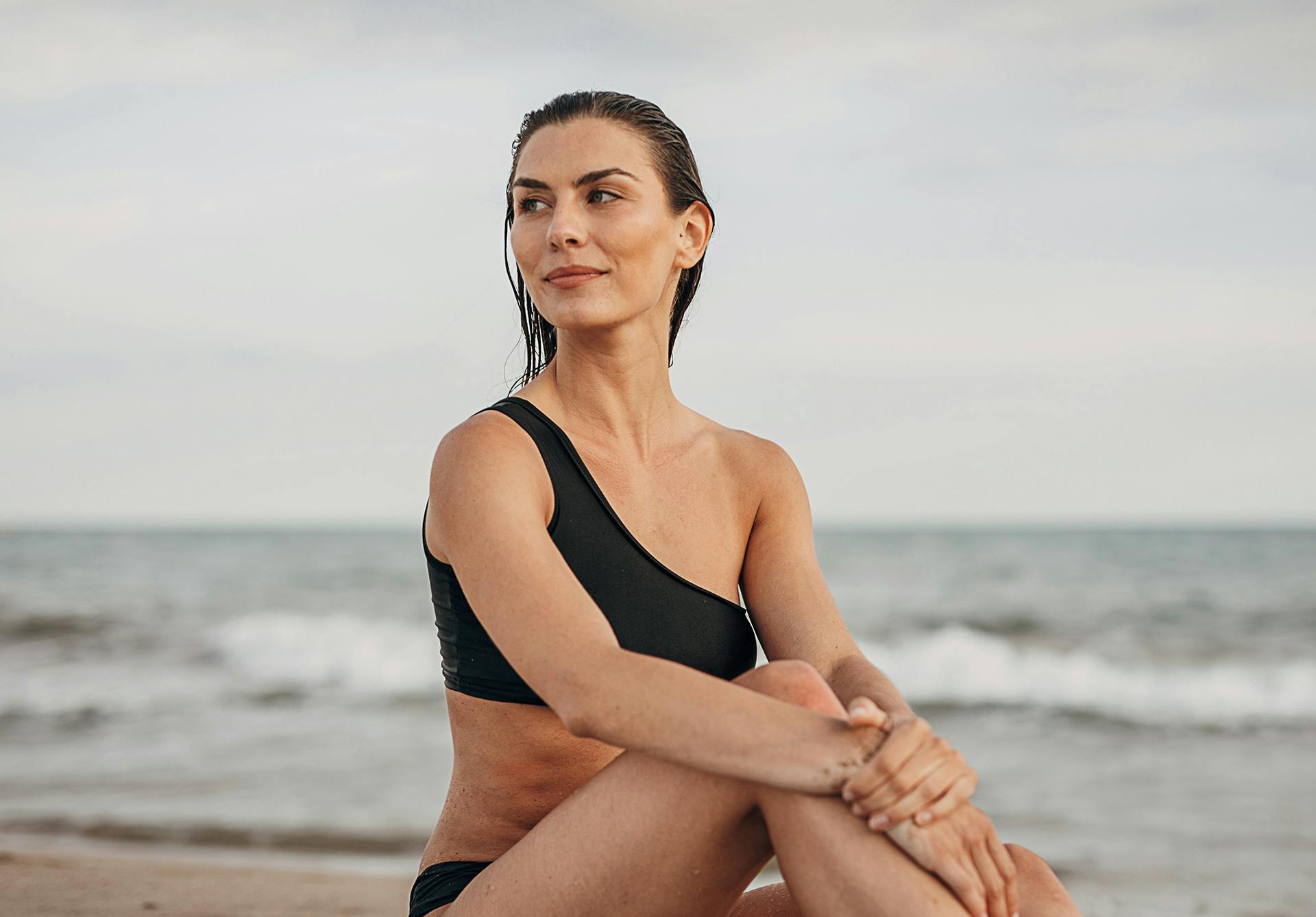 woman looking into the distance on the beach