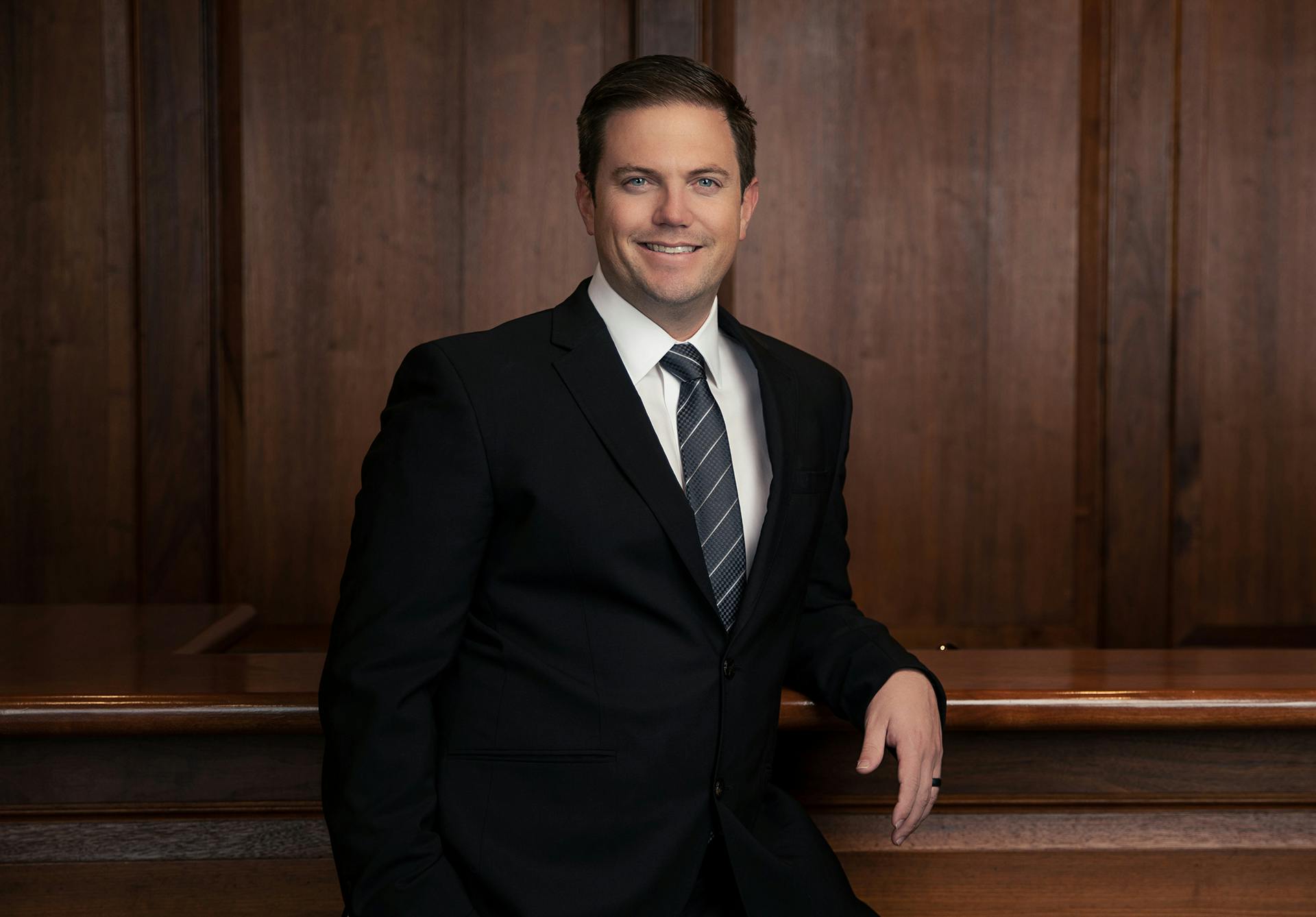 Dr. Mcgregor in black suit smiling