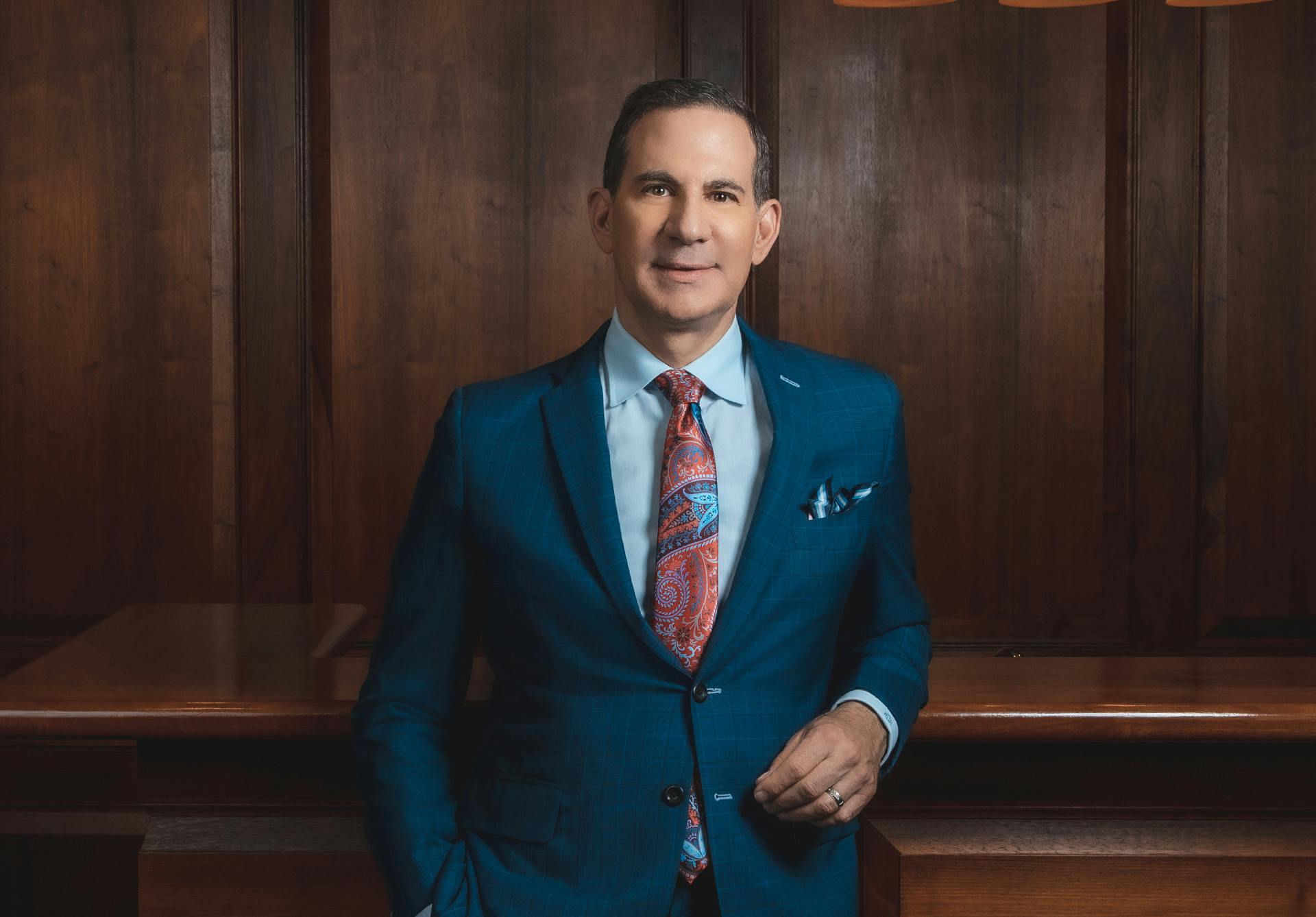 Dr. Clevens in blue suit smiling