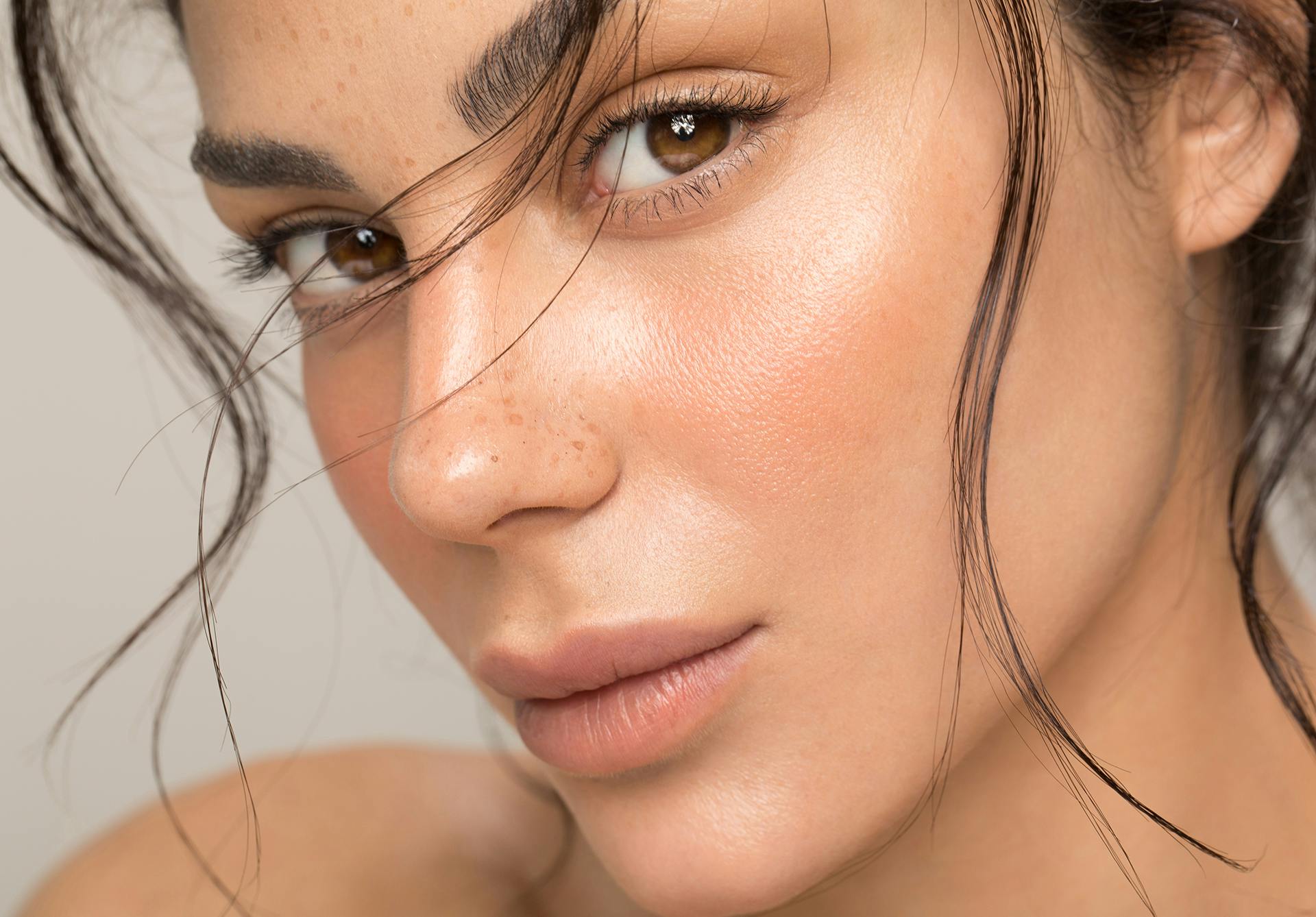 Beautiful woman with clear skin, freckles, and brown eyes