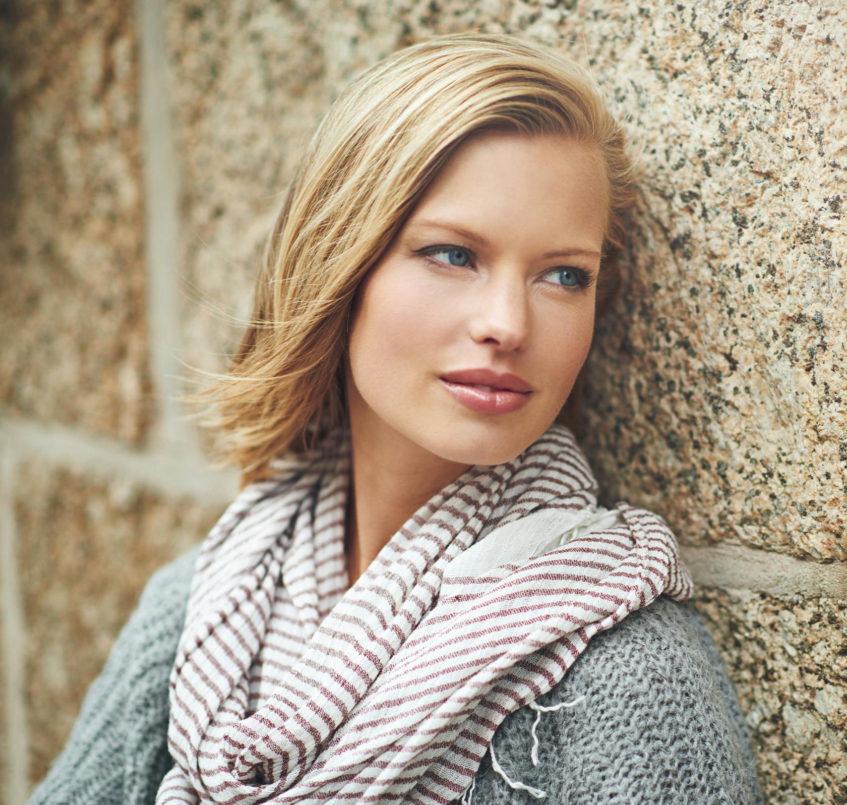 Pretty woman with short blond hair wearing a striped scarf