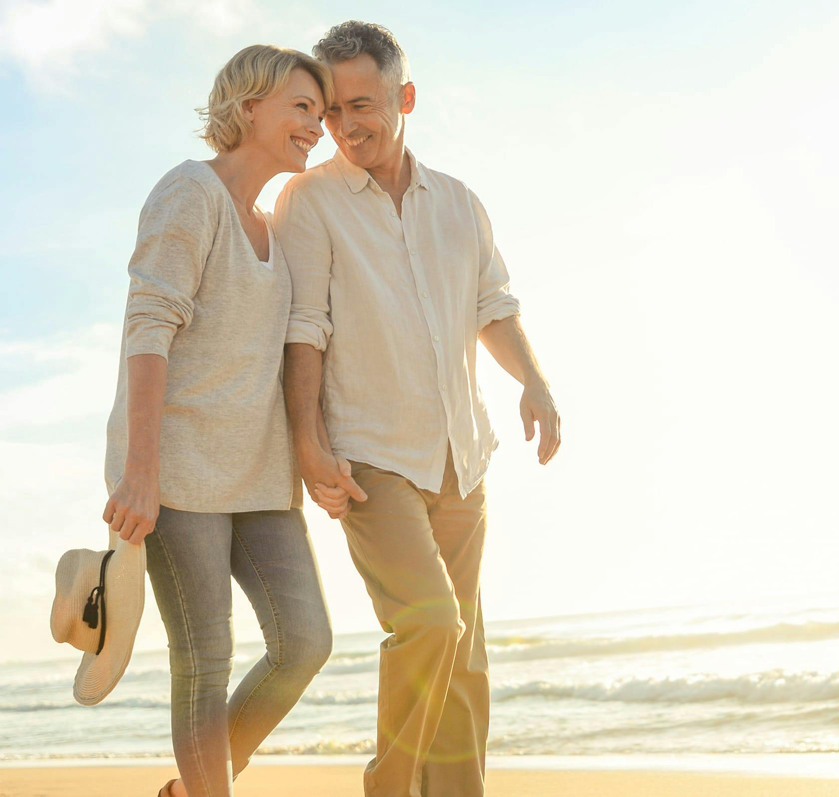 older couple walking on the beach