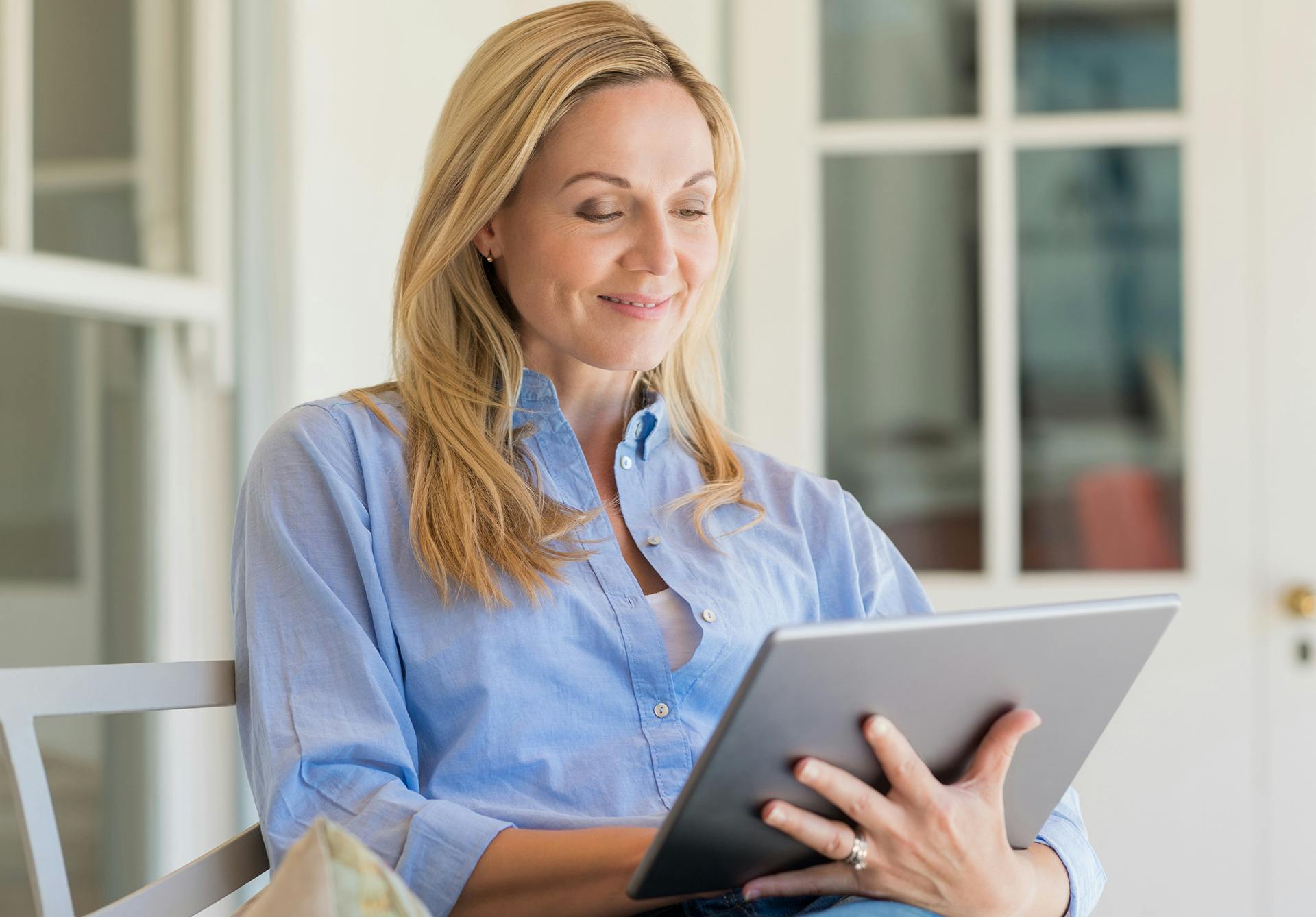 woman on i pad smiling