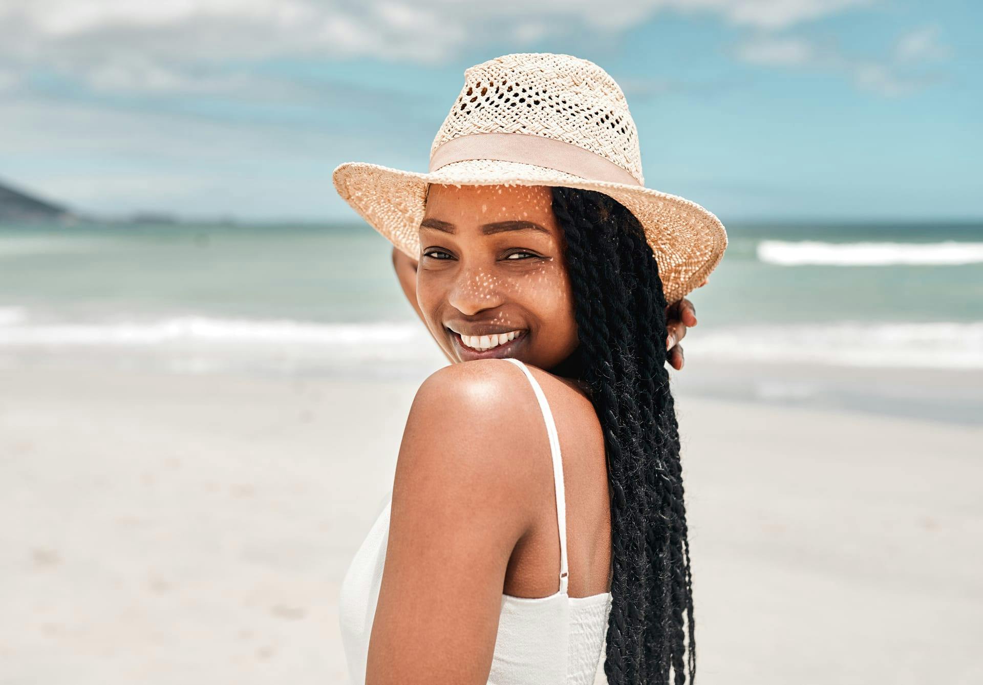Woman at the beach wearing a straw hat