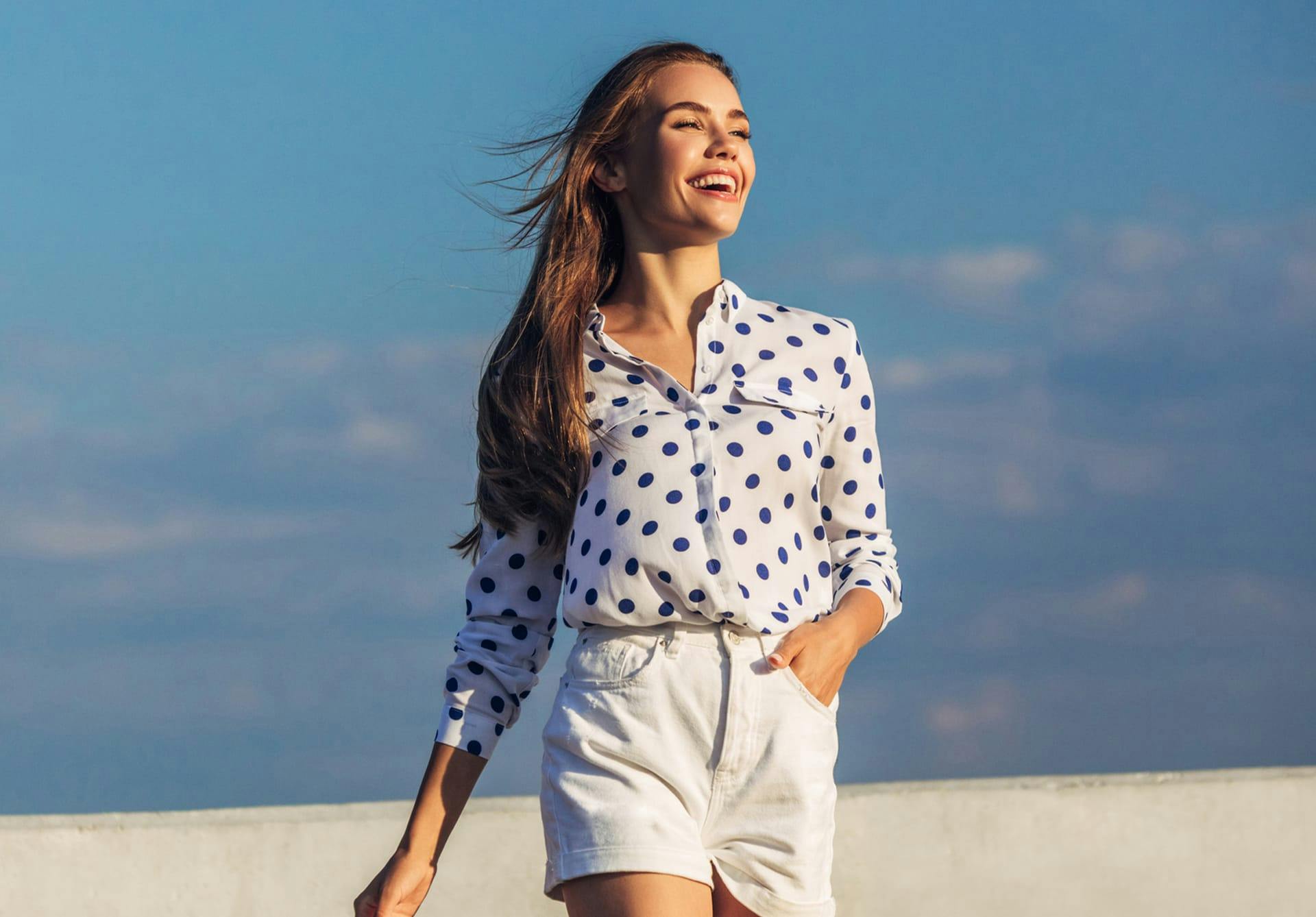woman in a polka dot top and white shorts