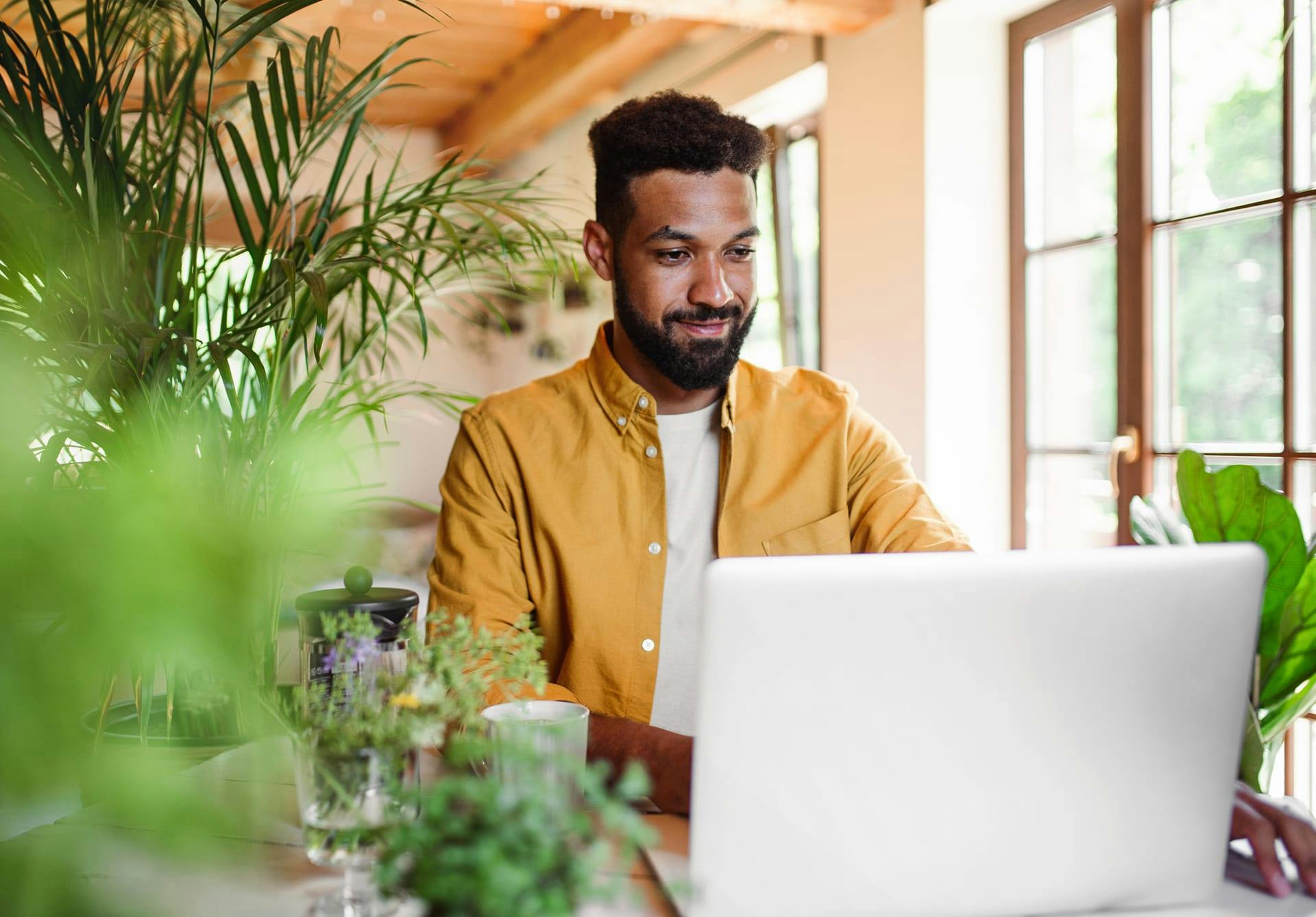 man looking at laptop and smiling
