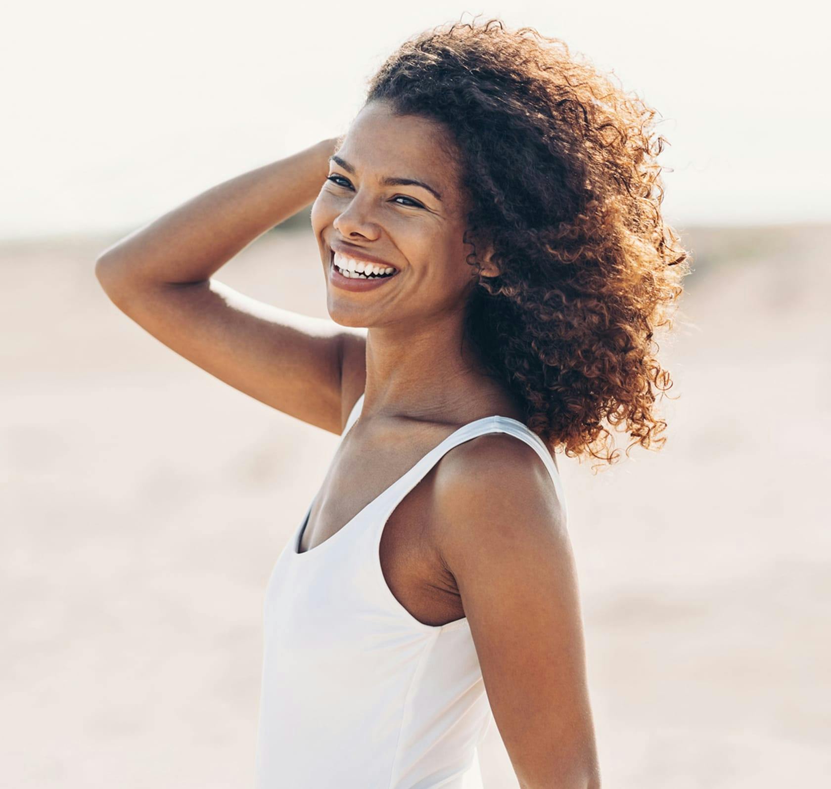 Woman at the beach laughing