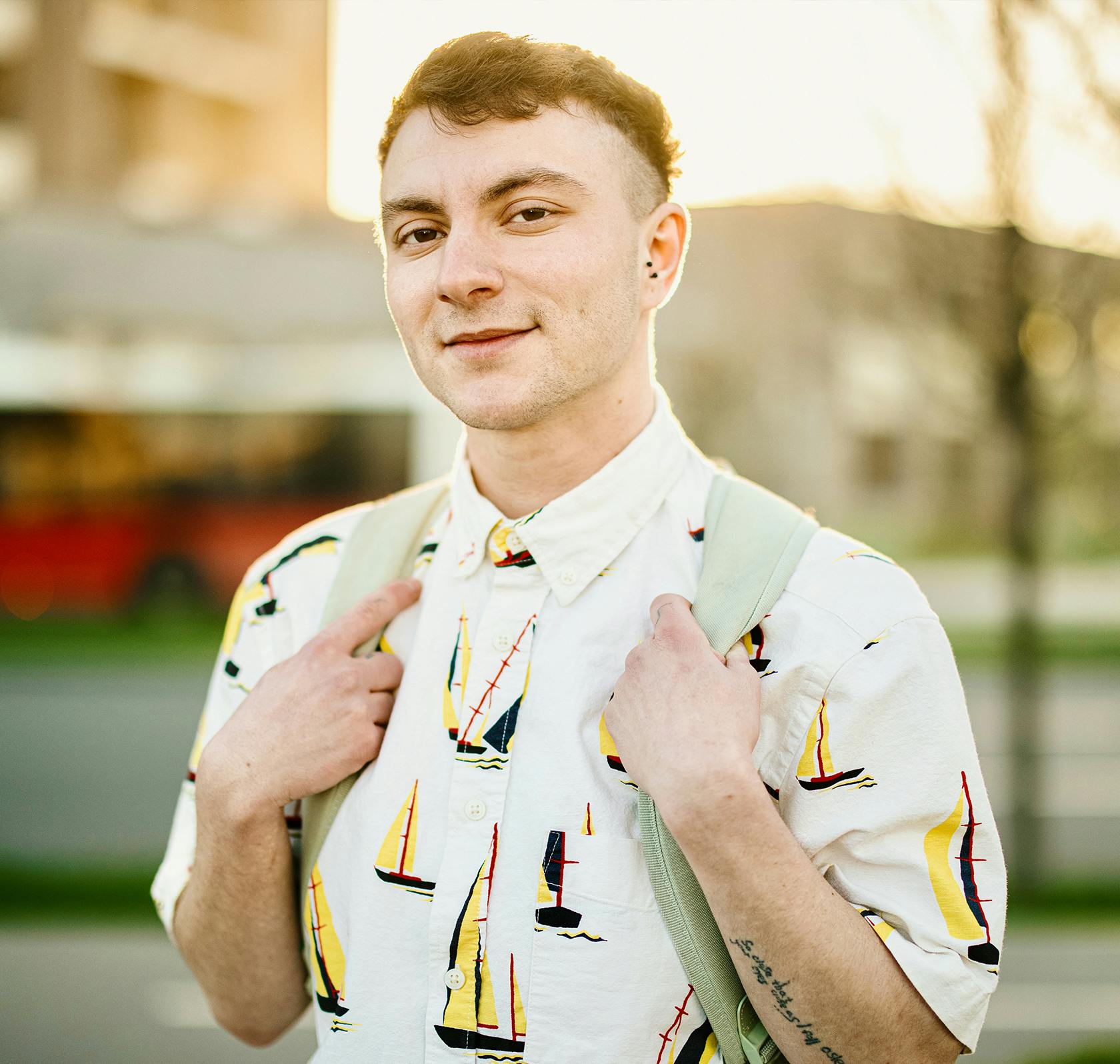 Man wearing a button up shirt with sailboats