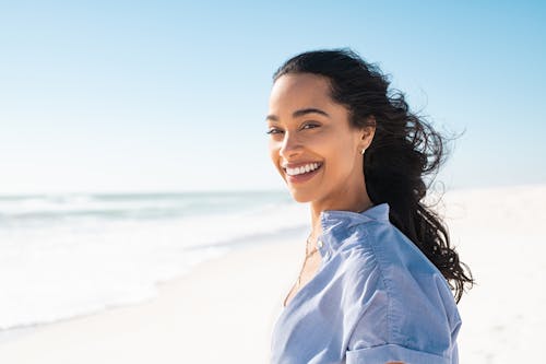 Woman smiling outside at the beach