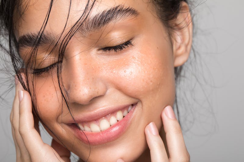 Woman smiling with her eyes closed