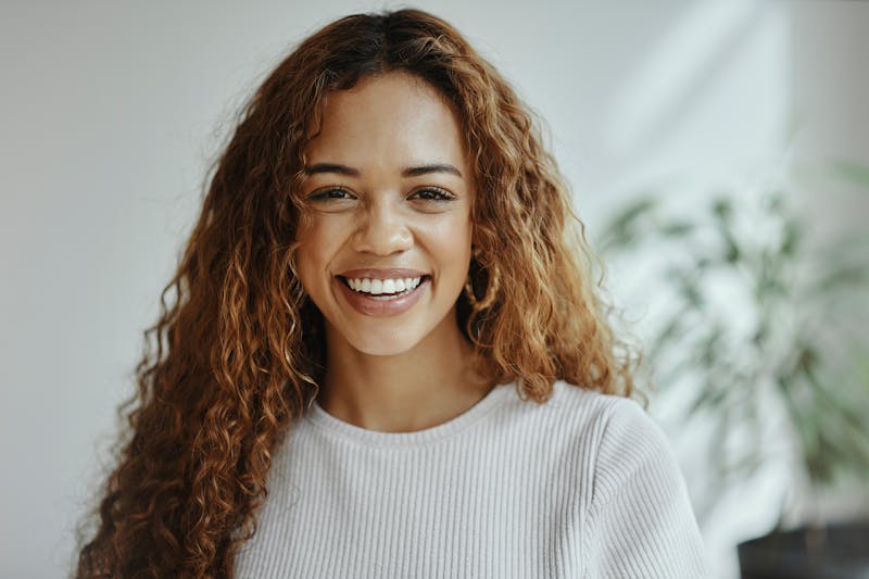 woman with long hair smiling