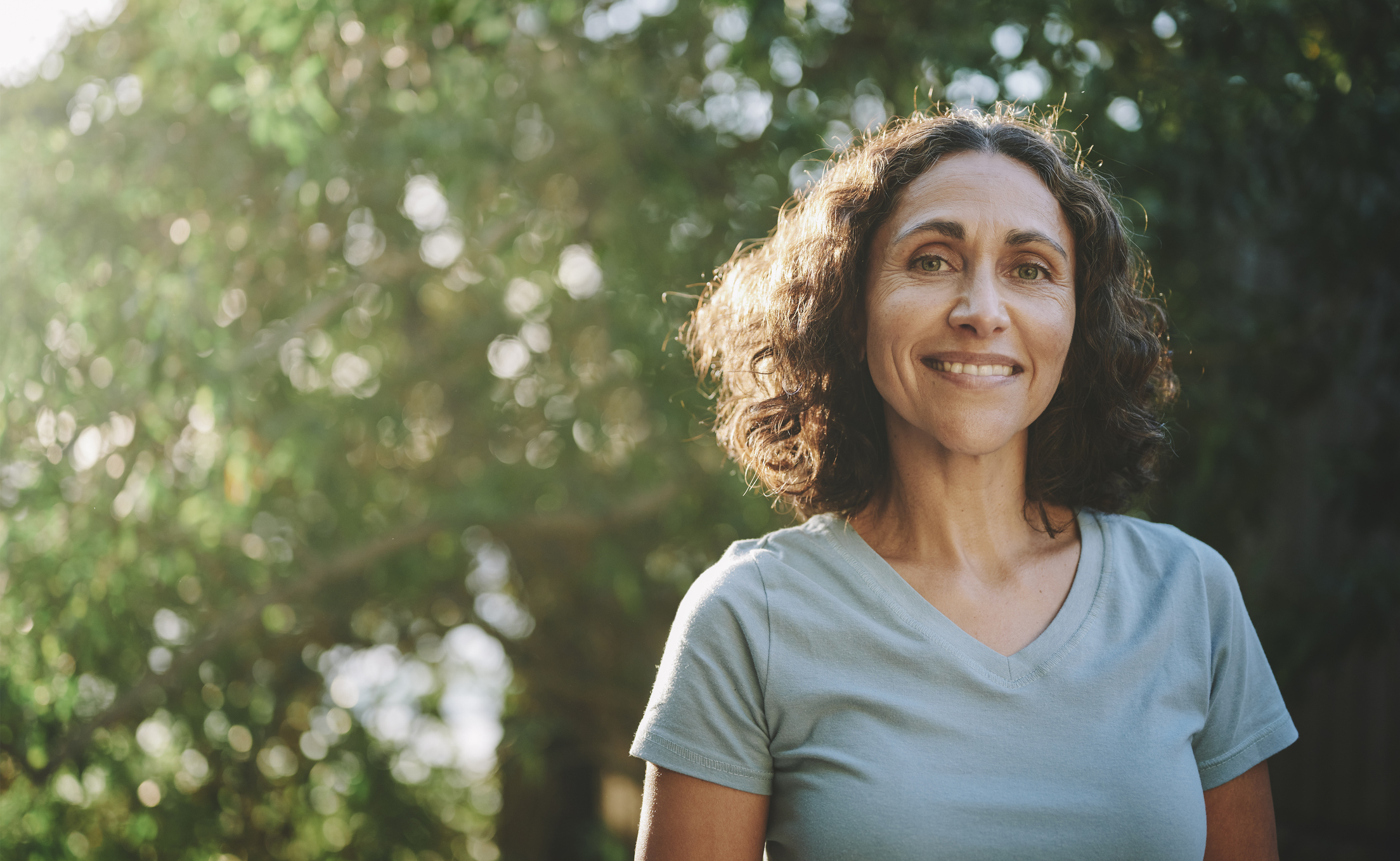 Woman outside smiling at camera