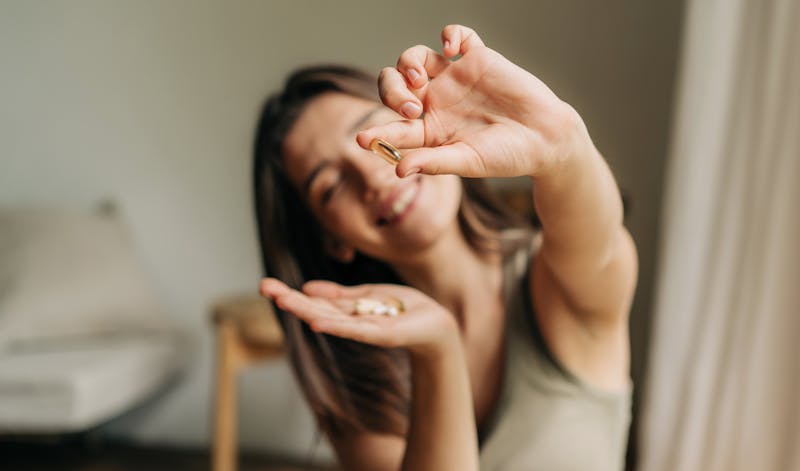 woman holding supplements