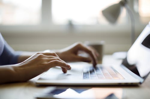 woman typing on computer