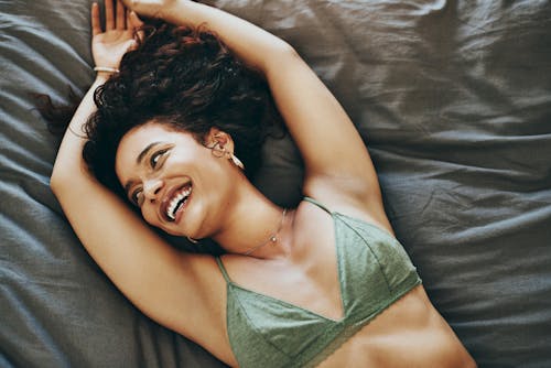 woman laying down in a green bra