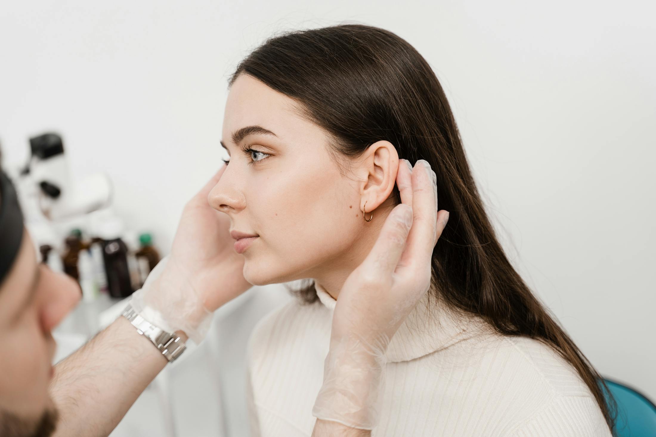 woman having ear looked at by doc