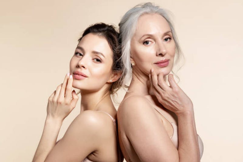 Two Women Standing Back to Back