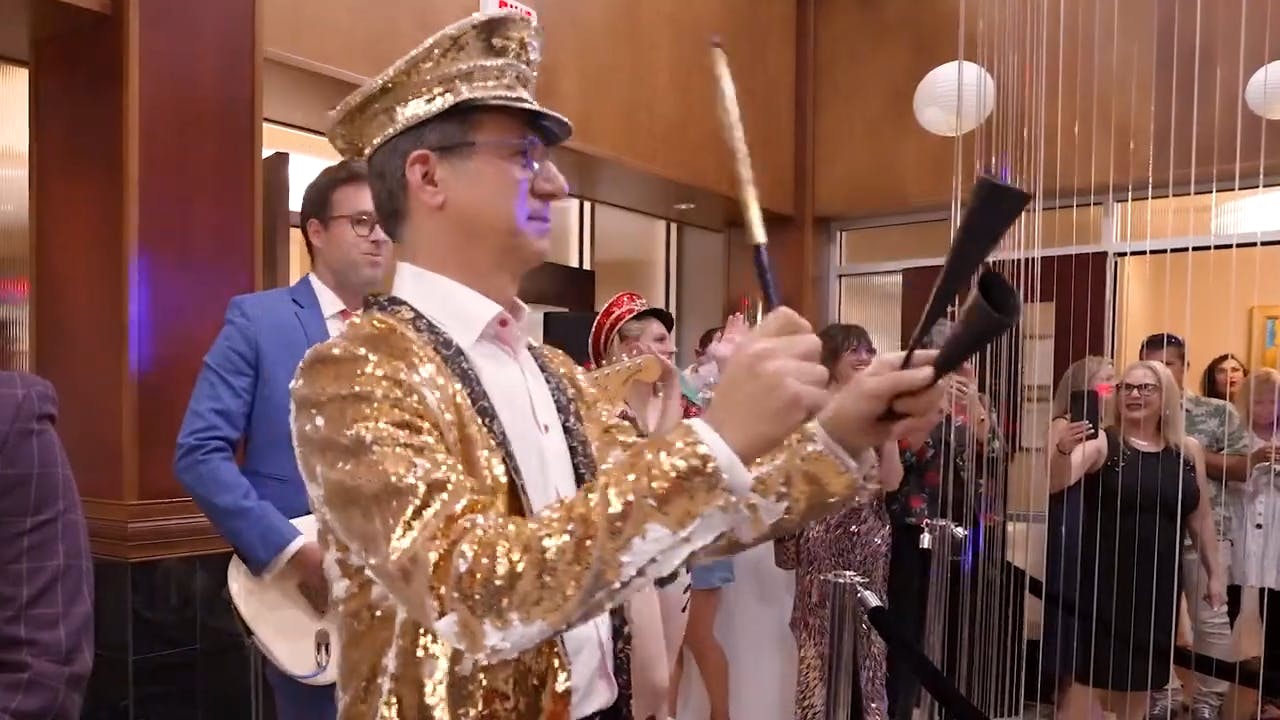 Dr. Clevens at an event with a gold suit