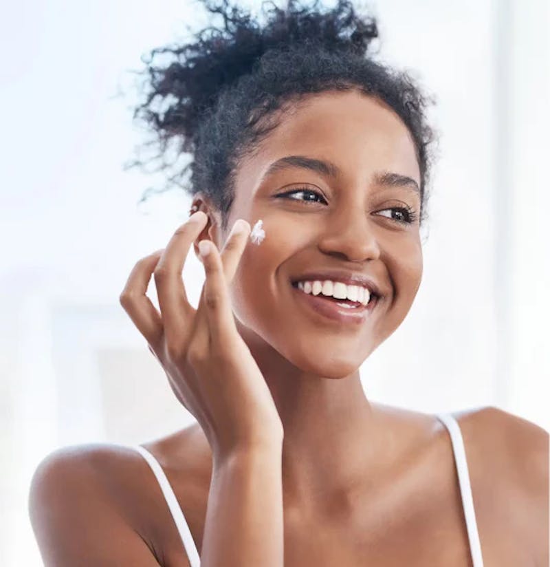 Woman Putting Sunscreen On
