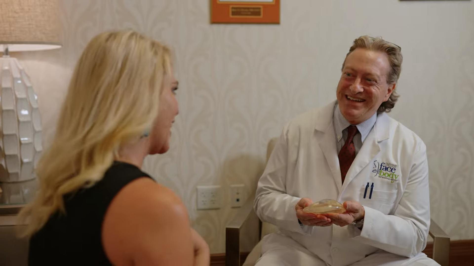 Male Doctor speaking to female patient