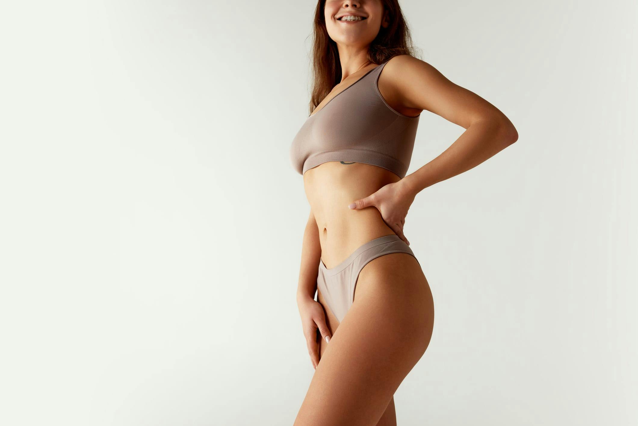 woman posing in tan undergarments