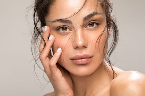 woman resting her hand on her cheek