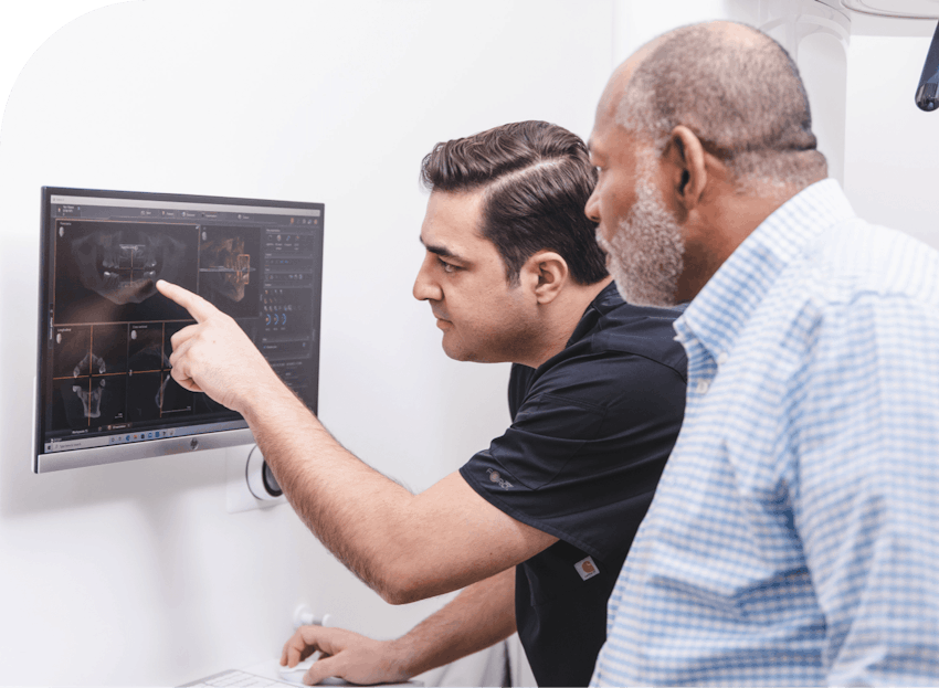 doctor showing patient x-ray for multiple dental implants burbank