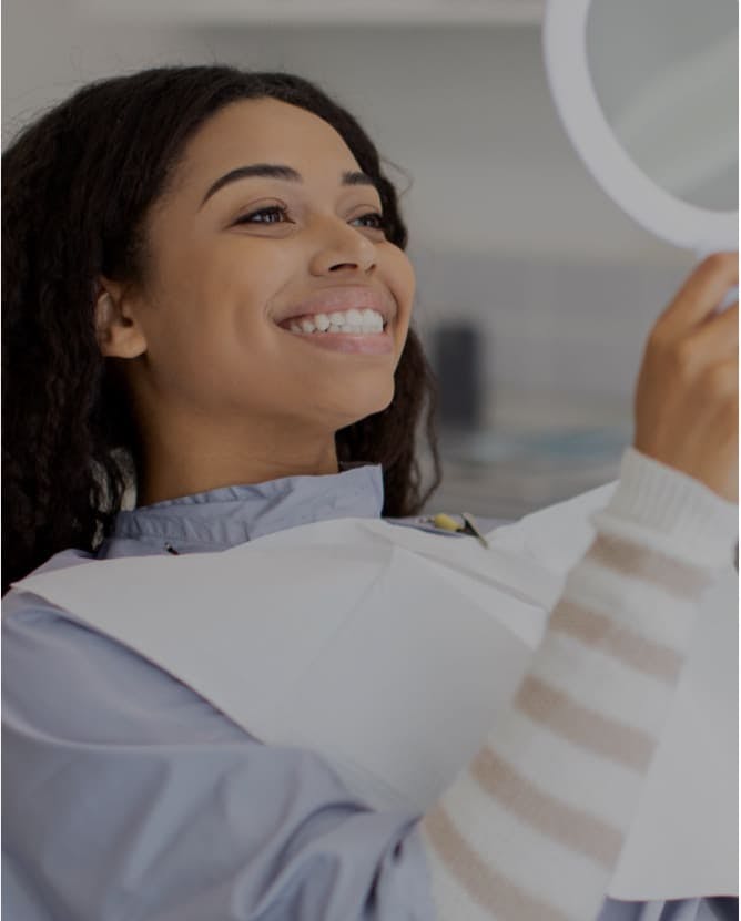 smiling woman after seeing best implant dentist burbank