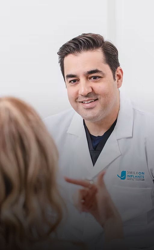 implant dentist in Fountain Valley talking with patient