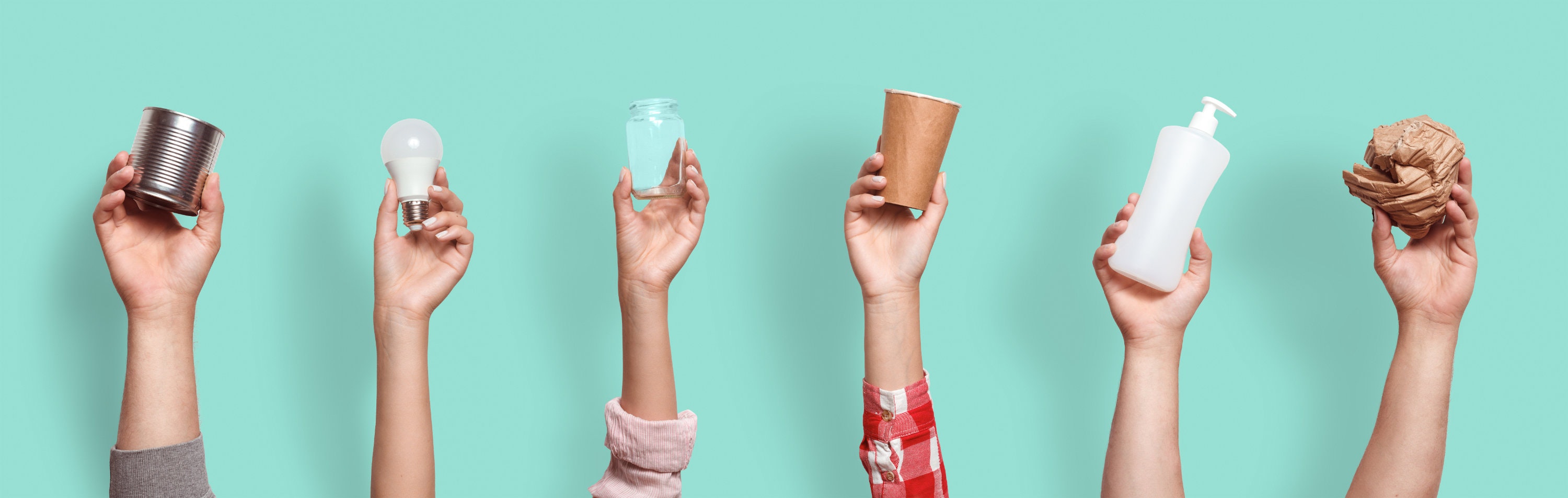 Different types of waste in the hands on a blue background. Sort garbage concept