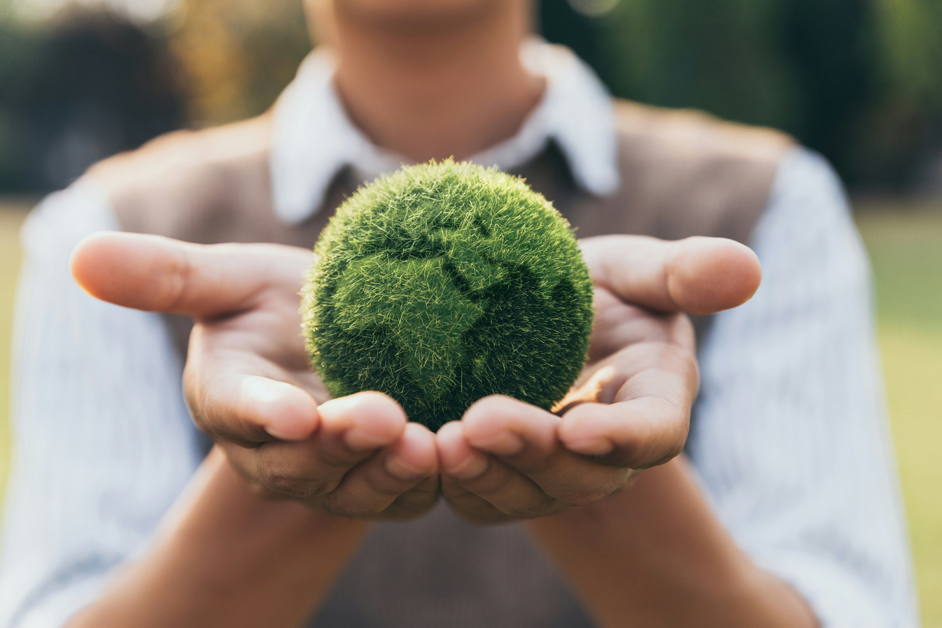 Teenager showing earth on hand, ecology and environment sustainable concept.