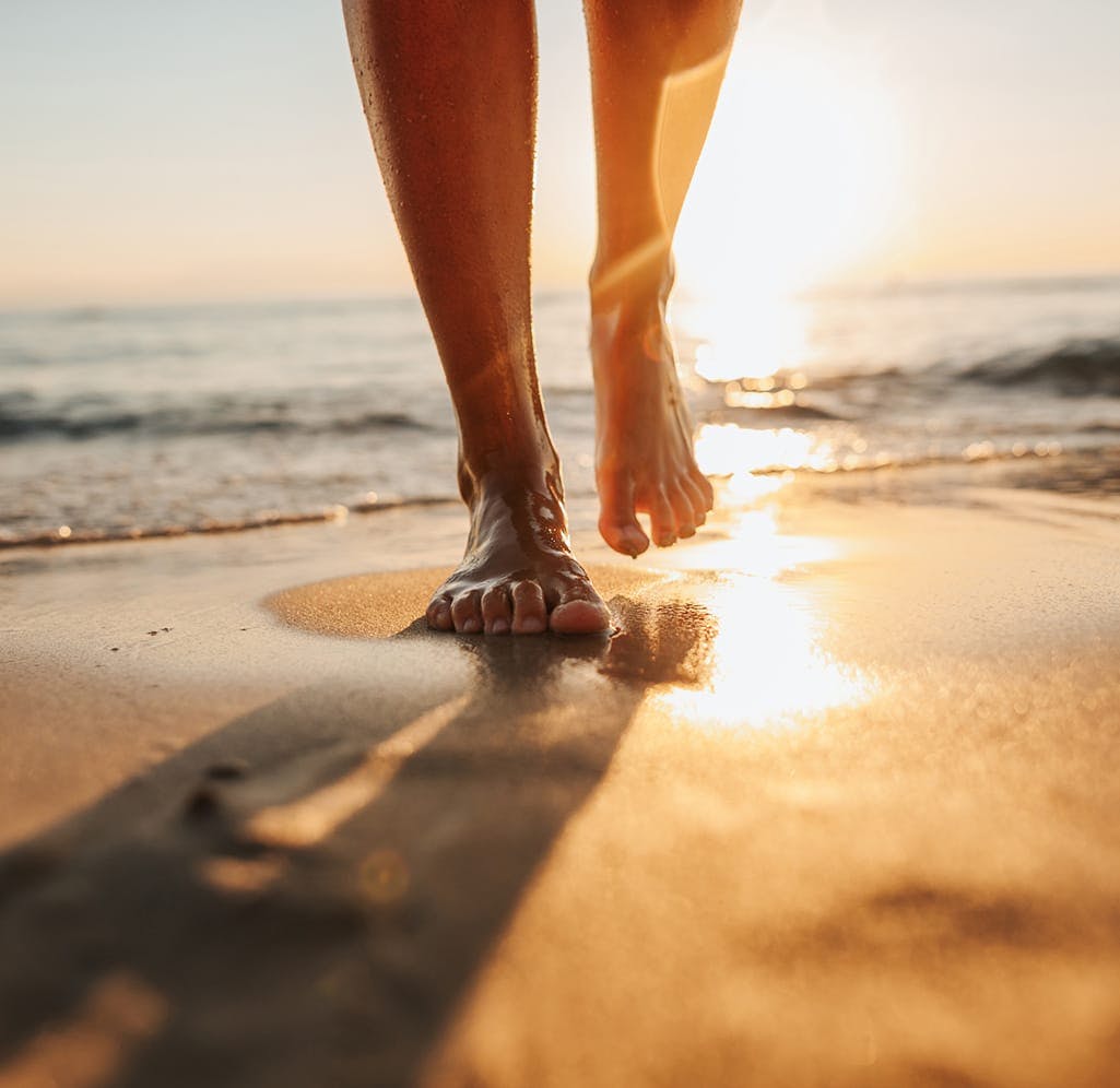 Legs of a person on the beach