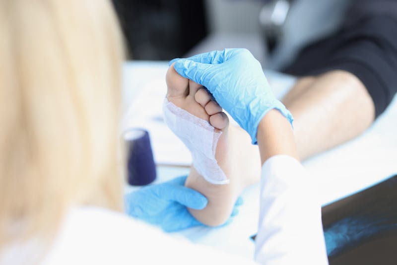 Nurse treating patient's foot