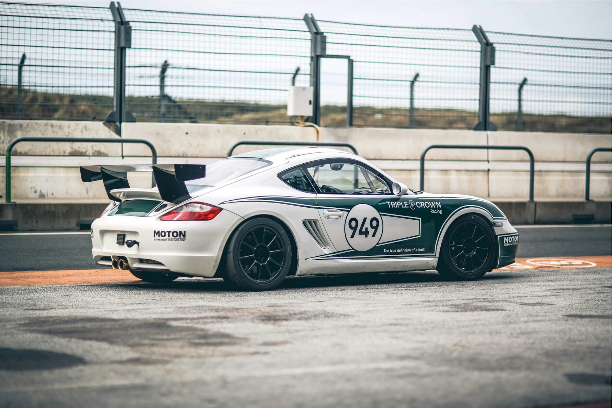 Porsche in race livery branding green stripes Stuurmen Triple Crown racing