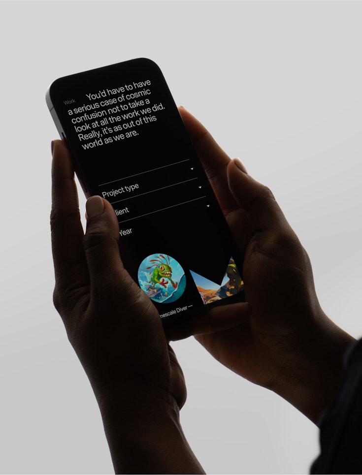 holding iphone with Mooncolony website open