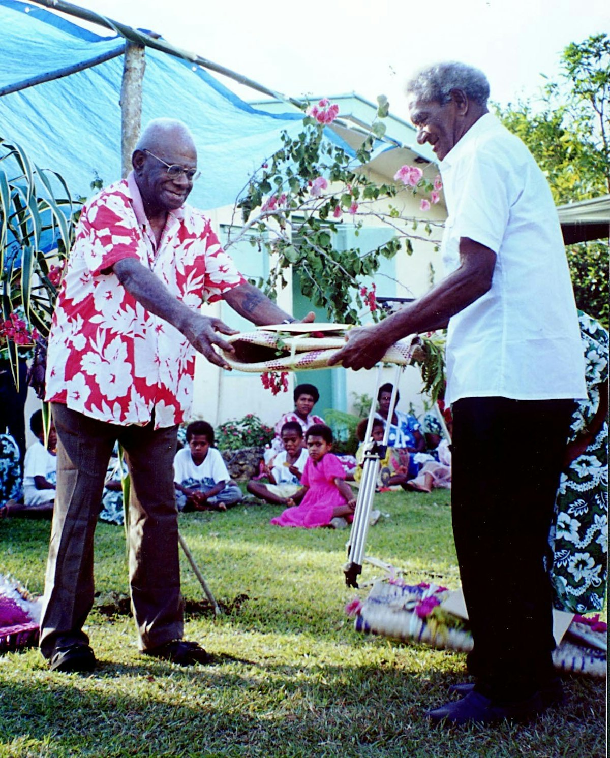 Chief Peter Poilapa receives a Bertha Dobbins Award for his contributions to a culture of peace at the grassroots level.| The award is presented by Peter Kaltoli on behalf of the Baha'is of Vanuatu at the fifth annual celebration of Bertha Dobbins Day, Port Vila, Vanuatu.