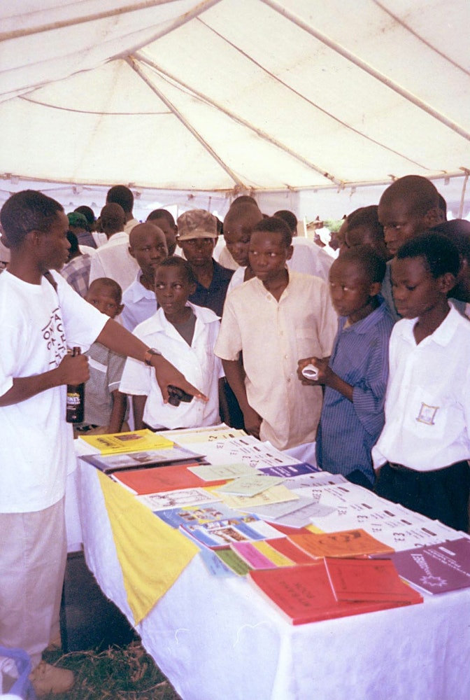 Visitors view the Baha'i literature table at Uganda's national United Nations Day commemoration.
