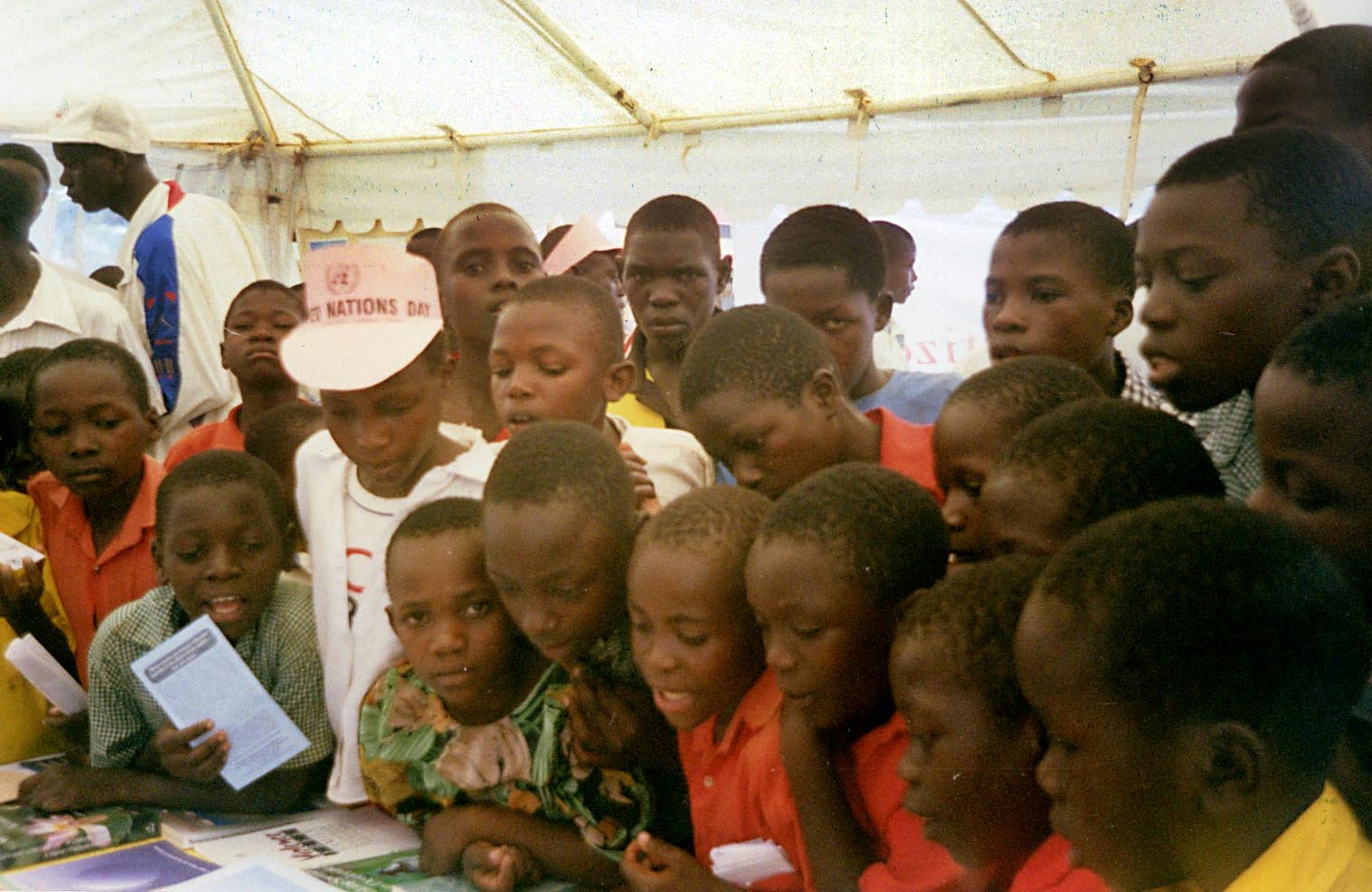Visitors view the Baha'i literature table at Uganda's national United Nations Day commemoration.