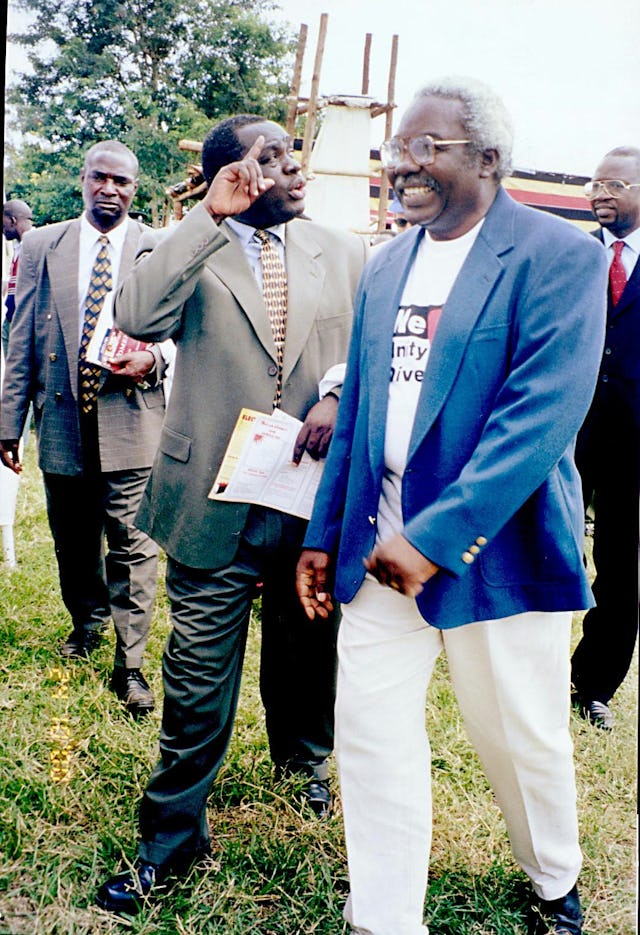 Uganda's Minister of Information, Basoga Nsadhu, is escorted to the Baha'i exhibit at Uganda's national United Nations Day commemoration by Mr. George Olinga, director of the Baha'i Office of External Affairs.