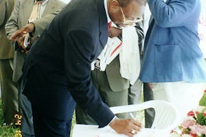 Mr. Dauda Toure, United Nations Resident Coordinator, signs the Guest Book in the Baha'i exhibit at Uganda's national United Nations Day commemoration.