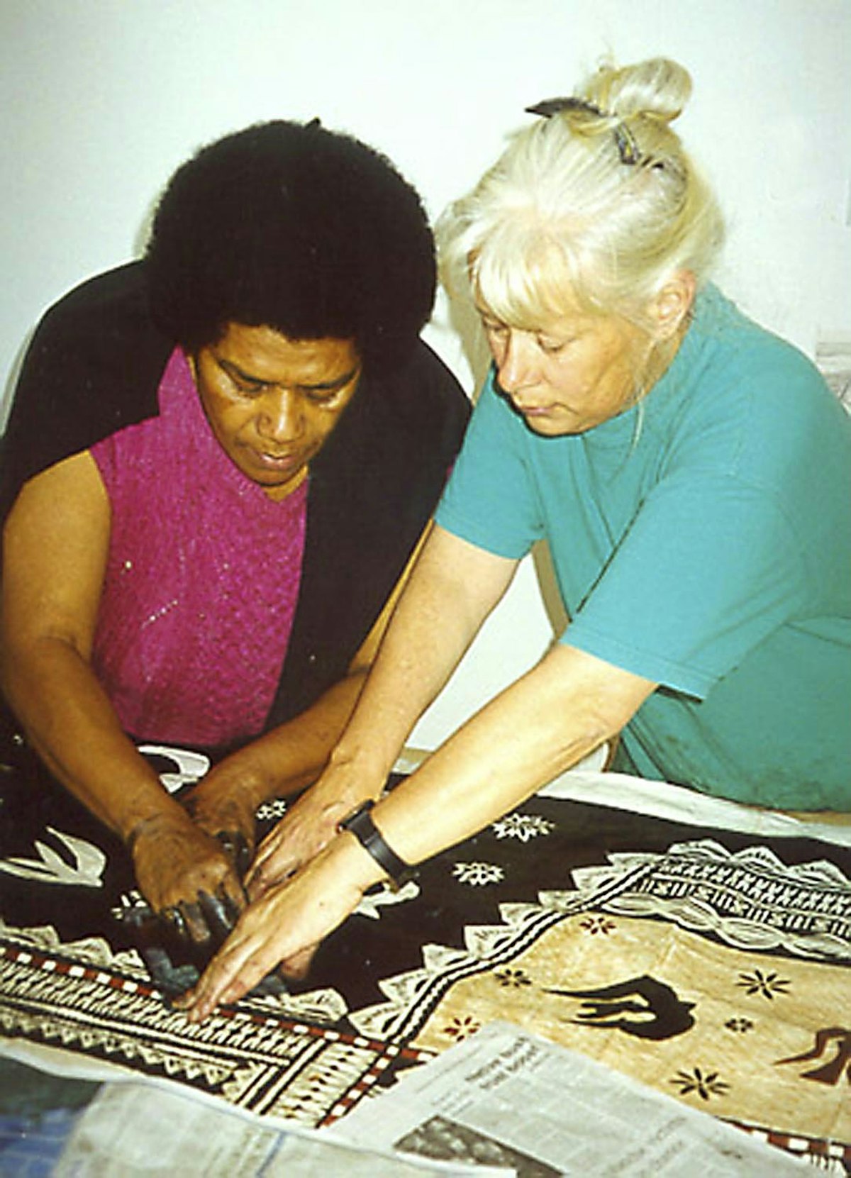 Leba Toki and Robin White apply decorative elements to the tapa cloth in Robin's studio in Masterton, New Zealand.
