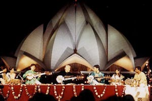 The sarod maestro Amjad Ali Khan, assisted by his sons Amaan Ali Bangash and Ayaan Ali Bangash, performs in the shadow of the Baha'i House of Worship in New Delhi. The concert, entitled "Sarod for Harmony," was part of the opening program of the Colloquium on Science, Religion and Development.